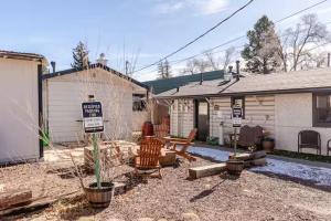 a house with a sign in a yard at Brews, Bites, & Pines - Your downtown Flagstaff suite in Flagstaff