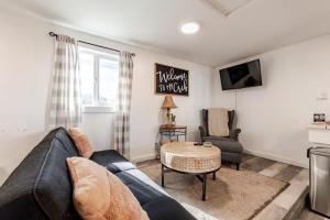 a living room with a couch and a table at Brews, Bites, & Pines - Your downtown Flagstaff suite in Flagstaff