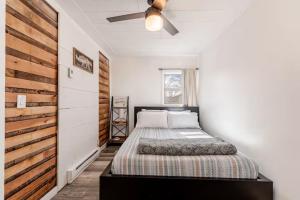 a bedroom with a bed and a ceiling fan at Brews, Bites, & Pines - Your downtown Flagstaff suite in Flagstaff