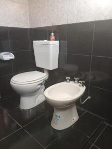 a bathroom with a toilet and a sink at Casa Camila in Villa Cura Brochero