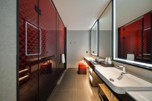 a bathroom with a sink and a large mirror at Madison Hotel Jinan CBD in Jinan +37 photos