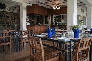a dining room with a long table and chairs at Forest Edge Resort in Kitulgala