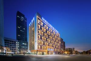 a lit up building in a city at night at Madison Hotel Jinan CBD in Jinan