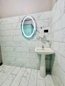 a white bathroom with a sink and a mirror at Casa de Campo Arenal in San Francisco +2 photos