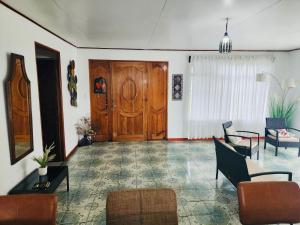 a living room with a large wooden door and chairs at Casa de Campo Arenal in San Francisco