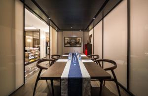 a dining room with a long table and chairs at Madison Hotel Jinan CBD in Jinan