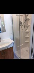 a bathroom with a shower and a sink at Brentwood Home in Burnaby