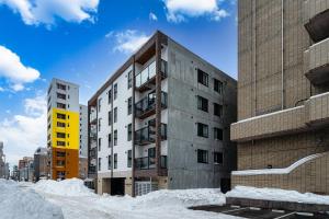 a building with snow in front of it at Zabo Hills 205 in Sapporo