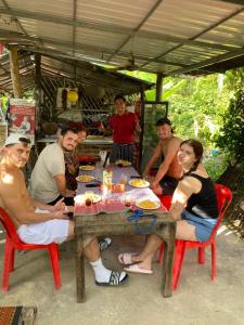 a group of people sitting around a table at Phonluer Angkor Homestay SiemReap - Local Vibe in Siem Reap