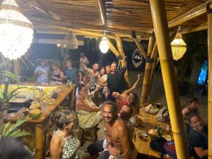 a group of people sitting at tables in a restaurant at La Bohème in Gili Islands +43 photos