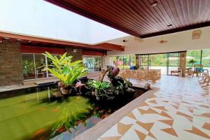 a living room with a fish pond in the floor at Hotel P INC General Santos in General Santos
