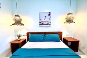 a bedroom with a blue bed and two night stands at Hotel P INC General Santos in General Santos