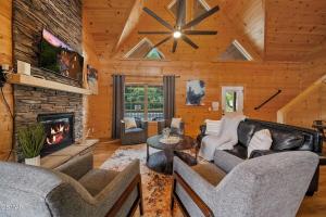a living room with couches and a fireplace at Cabin in Sevierville in Sevierville