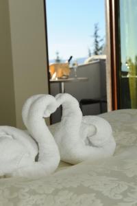 a pile of towels sitting on top of a bed at Millenium Palace in Ohrid