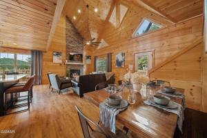 a dining room and living room with a wooden ceiling at Cabin in Sevierville in Sevierville