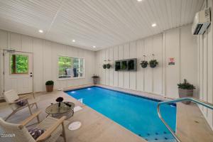 a swimming pool in a room with a table and chairs at Cabin in Sevierville in Sevierville