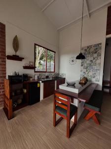 a kitchen with a table and a dining room at Villa Monarca - Markinkia Estancia Amazónica in Macas