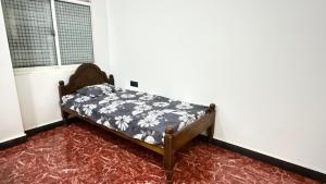 a bed sitting in a corner of a room at Nikshi Guest House in Nikawatawana