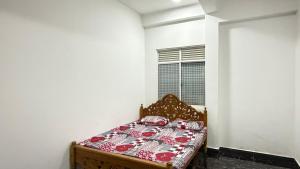 a bedroom with a bed in a white room at Nikshi Guest House in Nikawatawana