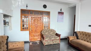 a living room with a chair and a door at Nikshi Guest House in Nikawatawana