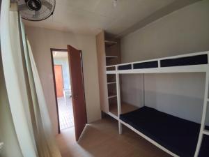 a bedroom with bunk beds and a door with a door at Bogartz Homestay in Mati