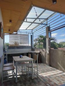 a patio with a table and chairs and a window at Bogartz Homestay in Mati