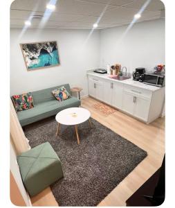 a living room with a couch and a table at Ubbies place in Regina