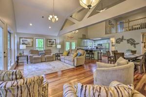 a living room with couches and a dining room at Dockside Lakefront Escape Deck Views in Jacksons Gap