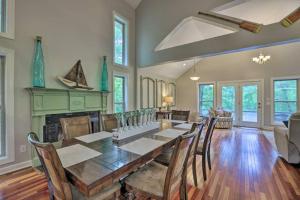 a dining room with a table and a fireplace at Dockside Lakefront Escape Deck Views in Jacksons Gap