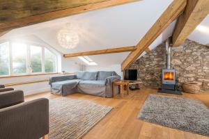 a living room with a couch and a stone fireplace at Ty Top in Newport