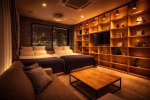 a living room with two beds and a couch at Fierement inn in Sapporo +17 photos