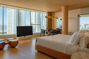 a hotel room with a bed and a television at The Grand Hotel in Punta del Este