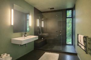 a bathroom with a sink and a shower at Blackpool House - Stay Waiheke in Oneroa