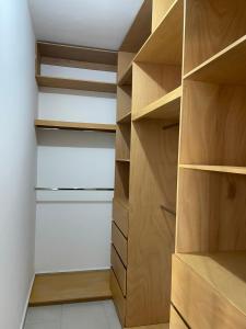 a walk in closet with wooden shelves at Loftstay MYO in Monterrey
