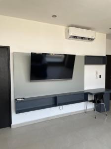 a flat screen tv hanging on a wall at Loftstay MYO in Monterrey