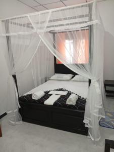 a bedroom with a bed with a canopy at Villa Aloe Vera- Signature Rooms in Weligama