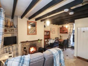 a living room with a couch and a fireplace at Merlin in Pwllheli