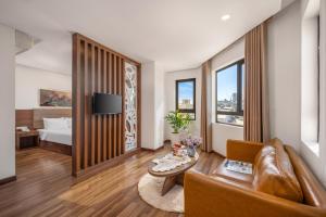 a living room with a couch and a bed at Lumina Hotel & Apartment in Danang