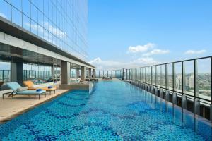 a swimming pool on the top of a building at Aloft by Marriott Jakarta Kebon Jeruk in Jakarta