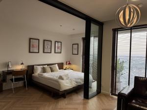 a bedroom with a bed and a desk and a window at CARTER Flat in Ho Chi Minh City