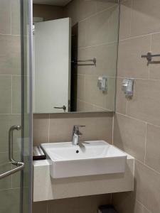 a bathroom with a white sink and a mirror at CARTER Flat in Ho Chi Minh City