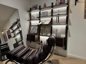 a black chair in a room with a shelf at CARTER Flat in Ho Chi Minh City