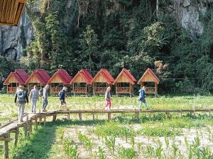a group of people walking across a wooden bridge at Phathokcamping in Ban Phathok