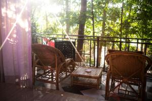 two chairs and a table on a porch at MESTO Koh Phangan - Creative Stay & Community Hub in Thong Sala