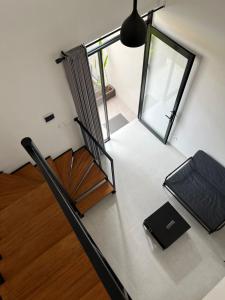 a room with a table with a chair and a window at Naung CoLiving in Kerobokan