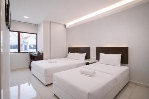 a hotel room with two beds and a window at GM Hotel Metro at Sunway in Petaling Jaya