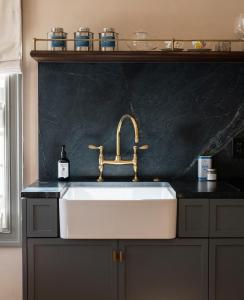 a kitchen sink with a black counter top at Gjelina Hotel in Los Angeles +52 photos
