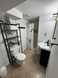 a bathroom with a toilet and a sink at Private Apartment for Business & Couples in Sudbury