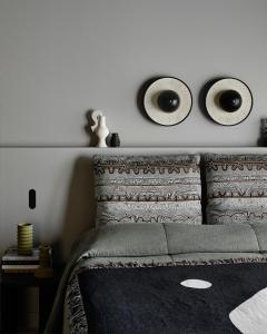 a bedroom with a bed with two mirrors on the wall at Bassano Red Hill in Red Hill +14 photos