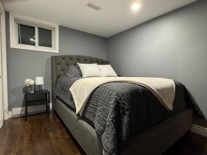 a bedroom with a bed and a window at Private Apartment for Business & Couples in Sudbury